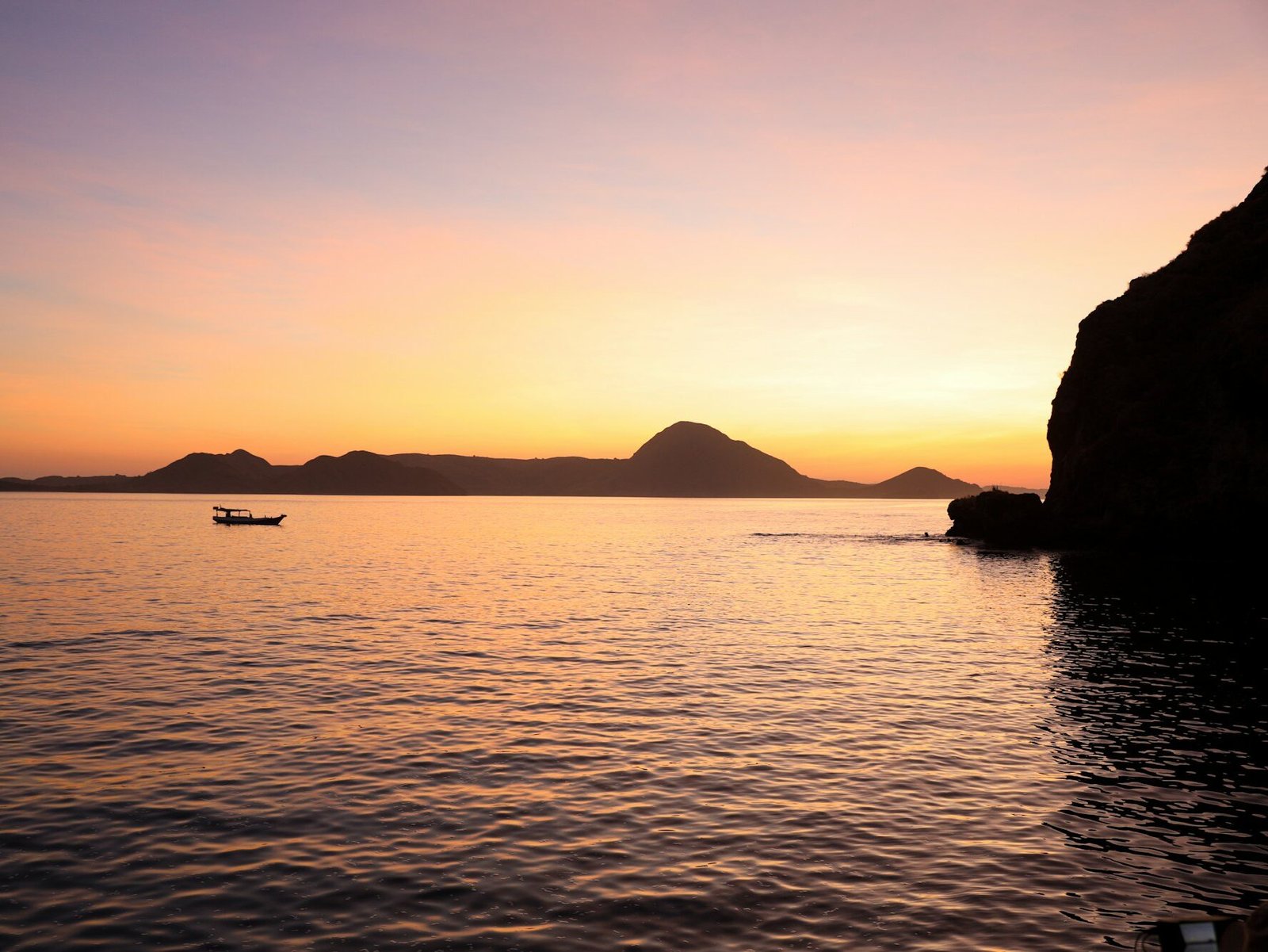 Sunset background on the sea with sailing boat