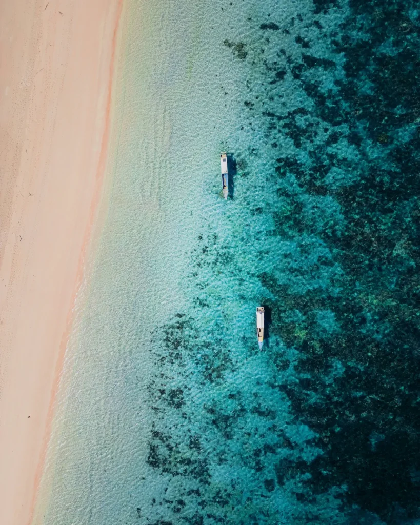 Aerial perspective showcasing the unique Pink Beach and coral reef.
