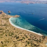 Aerial image showing speedboats coming and going at Pink Beach.