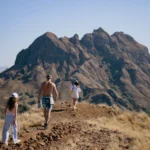 Family heading to a scenic cliff edge to snap photos on Padar.