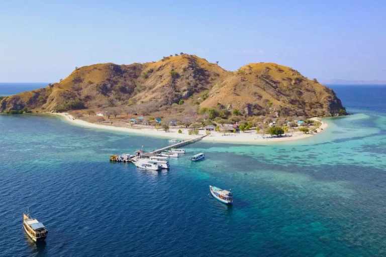 Visitors arriving and leaving Kanawa Island with colorful sea backdrop.