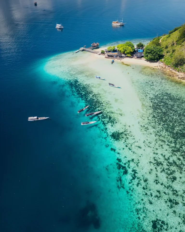 Drone image highlighting the coral-filled shallows around Kelor.