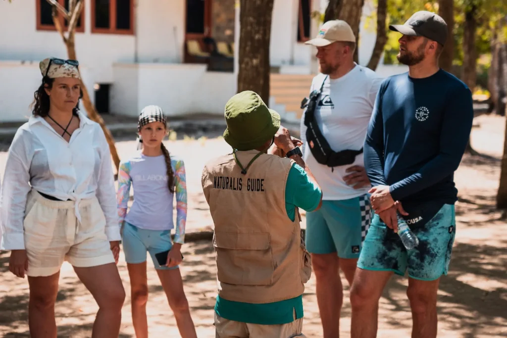 Family group listening to a ranger’s introduction before exploring Komodo island, komodo village, komodo national park