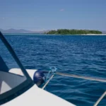 Clear ocean and uninhabited island seen from the front of Athar speedboat.