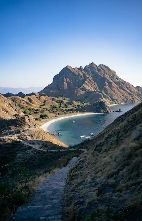 Wooden stairs leading to the beach with Padar hills in view