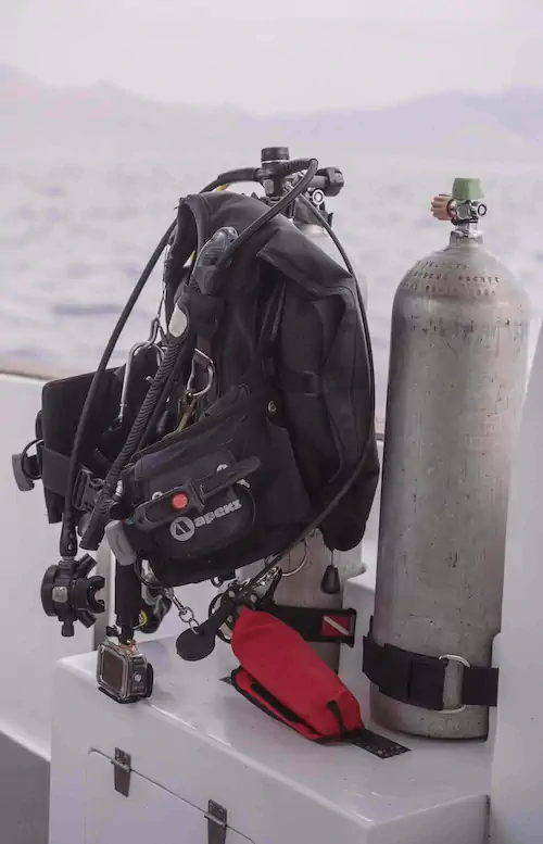 Scuba diving equipment setup on the deck of Como
