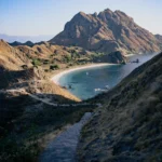 Wooden staircase leading to Padar Beach with scenic view.