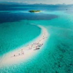Drone view of visitors posing and playing on the Taka Makassar sand dune.