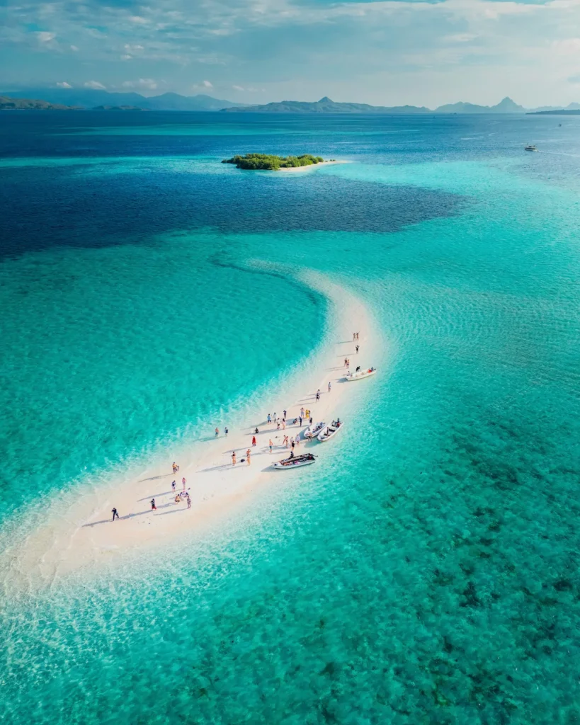 Drone view of visitors posing and playing on the Taka Makassar sand dune.
