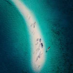 Overhead shot of tourists enjoying a group photo on Taka Makassar.