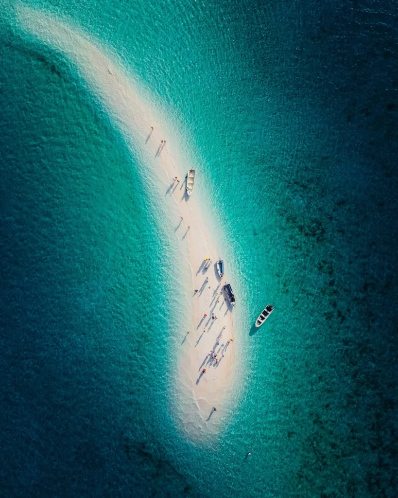Overhead shot of tourists enjoying a group photo on Taka Makassar.